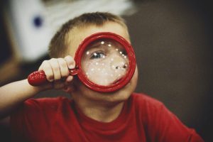 Little boy with Red Magnifying Glass