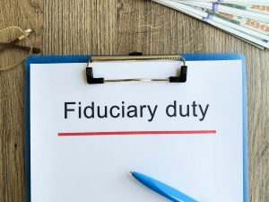 Paper with text fiduciary duty on wood table