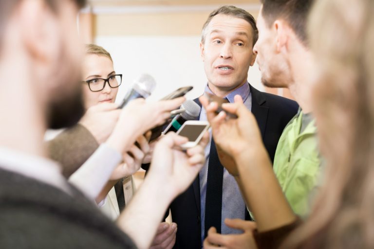 Reporters Interviewing Businessman