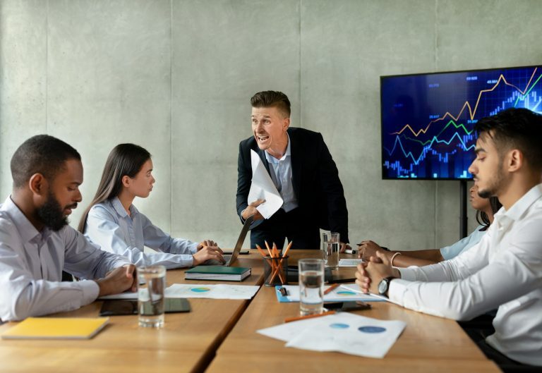 Toxic Boss. Angry Businessman Shouting At Workers During Corporate Meeting In Office